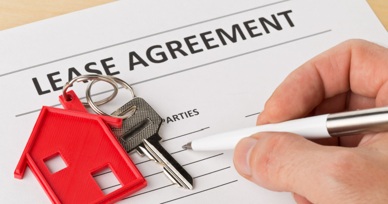 Landlord and tenant reviewing a lease agreement with key clauses highlighted